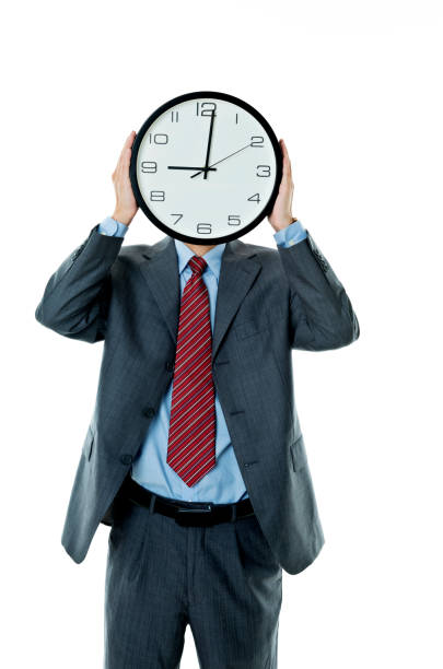 horloge holding homme d’affaires sur fond blanc - clock time clock hand urgency photos et images de collection