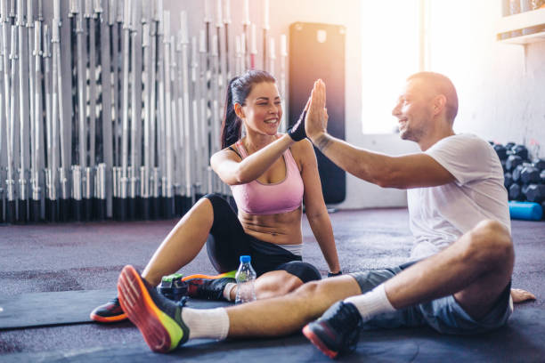 istock Sporty couple high five at gym 841944362