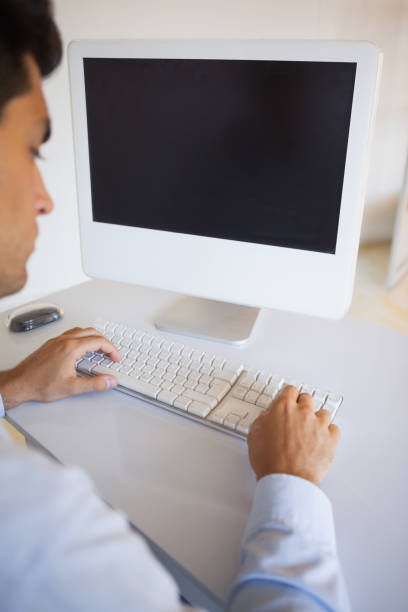 istock Businessman typing on keyboard at desk 841955030