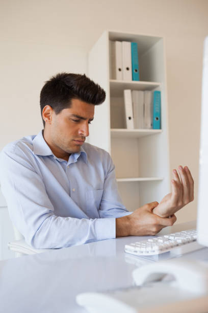 istock Casual businessman touching his sore wrist 841955132