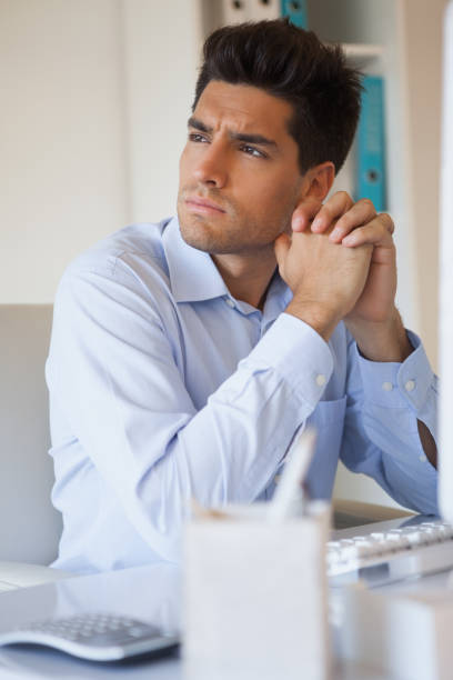 istock Casual businessman thinking at his desk 841955262