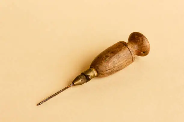 old wooden and metal tool for working wool