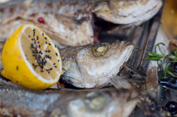 Herring or other salted fish with lemon on the restaurant table