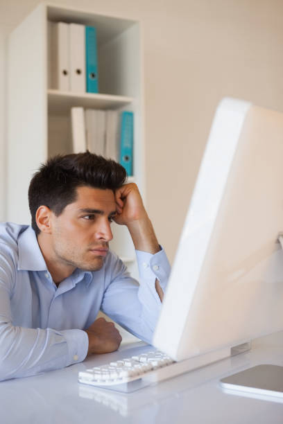 istock Casual businessman slumped at his desk 841969354