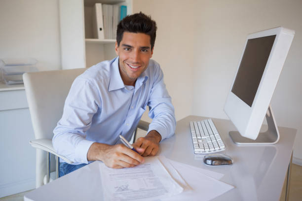 istock Casual businessman sitting at desk writing 841971406
