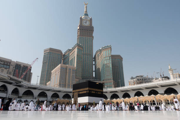 Mecca, Saudi Arabia - September 10, 2016: Muslim pilgrims put on their white ihrams circling around the holy Kaaba at daytime during Hajj in Saudi Arabia
