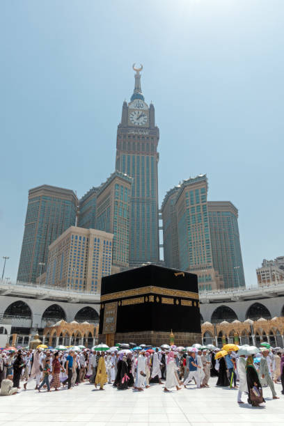Mecca, Saudi Arabia - September 13, 2016: Muslim pilgrims put on their white ihrams circling around the holy Kaaba at daytime during Hajj in Saudi Arabia