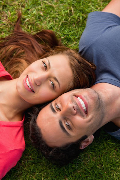 istock Close up of two friends smiling while lying head to shoulder 841974916