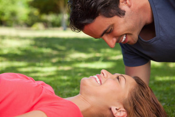 istock Man smiling as he looks down into his friends eyes 841975012