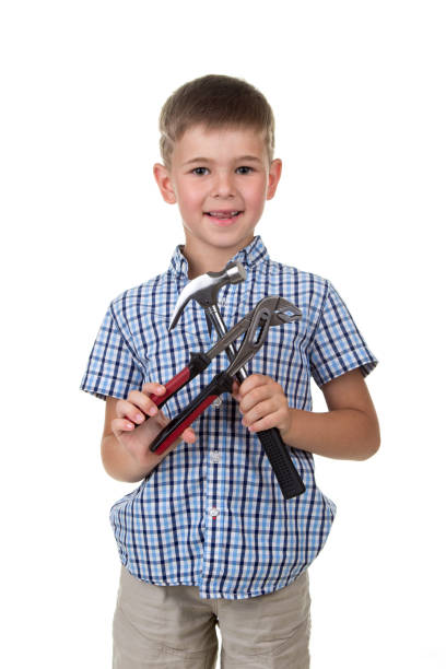 istock cute little boy in blue checkered shirt, holding building instruments, isolated on white background 841975076