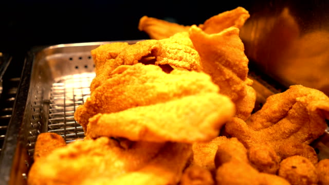 Close-up of Delicious Fried Fish & Hush Puppies Under Warmers