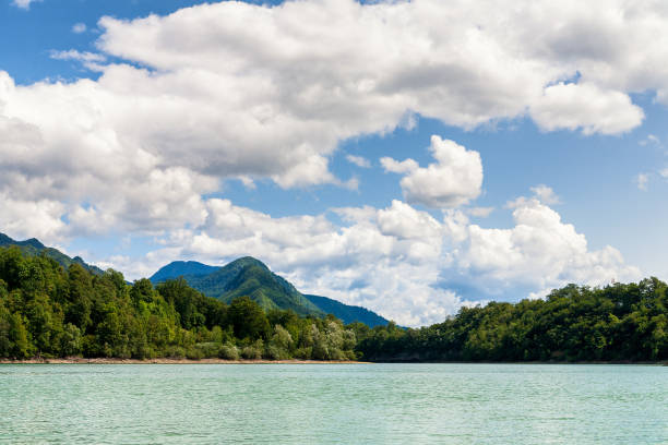 Mountain and fluffy clouds over lake, Slovenia Mountain and nice white fluffy clouds over lake near Jesenice town in Slovenia. Summer day. municipality of jesenice photos stock pictures, royalty-free photos & images