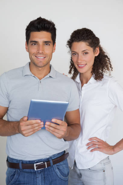 istock Casual business team looking at tablet together 841984914
