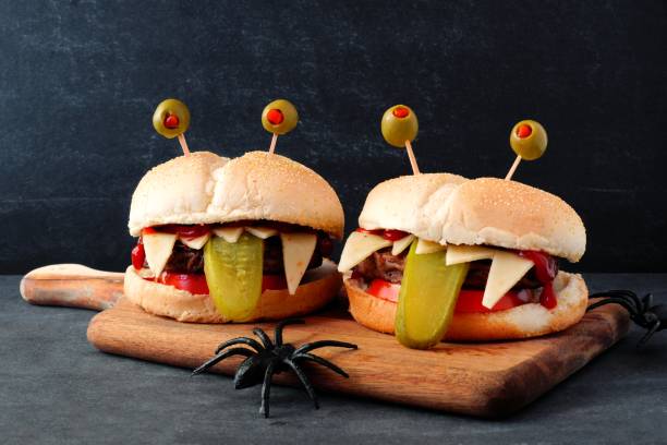istock Halloween monster hamburgers against a black background 841994434