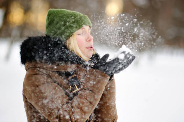 istock Young women having fun with snow 841997458