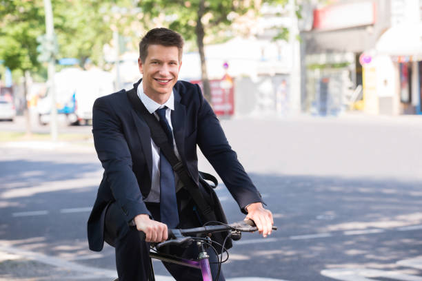 istock Male Businessman Riding Bicycle 841998674