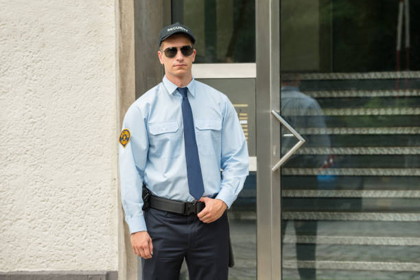 istock Male Security Guard Standing At The Entrance 842004240