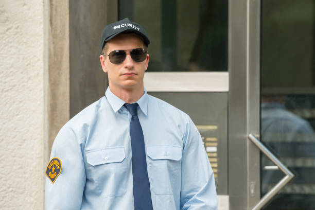 istock Male Security Guard Standing At The Entrance 842004262