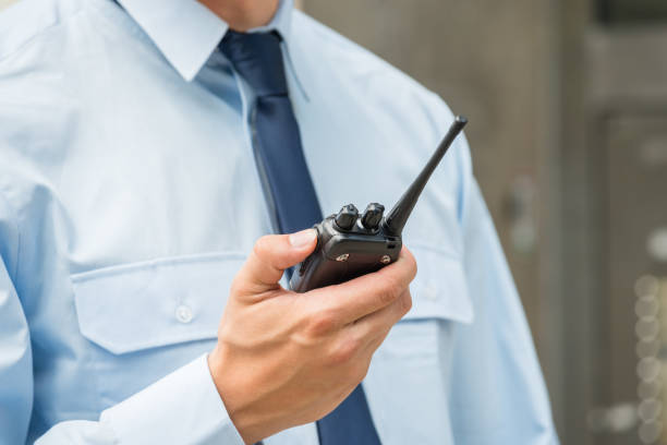 Security Guard Holding Walkie-talkie Close-up Photo Of Security Guard Holding Walkie-talkie walkie talkie photos stock pictures, royalty-free photos & images