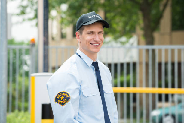 Happy Male Security Guard Portrait Of A Happy Young Male Security Guard police force smiling officer stock pictures, royalty-free photos & images