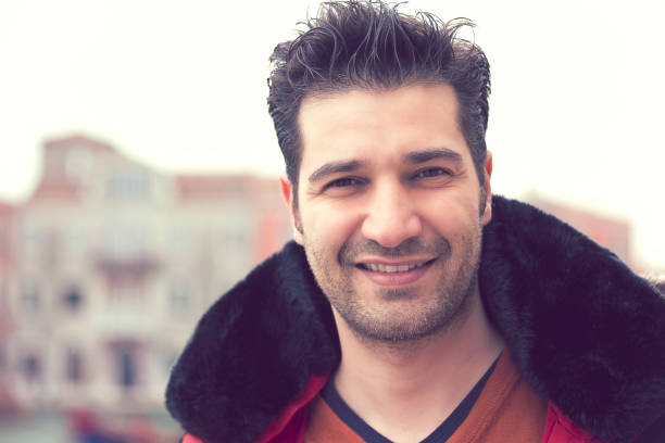 istock Happy young man standing outdoors on a background of an old town 842012032
