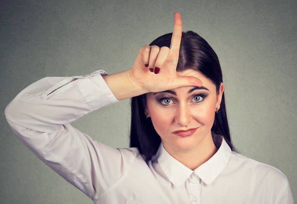 istock Angry woman showing loser sign looking at camera 842012052