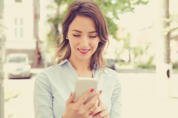 istock City happy woman using mobile phone 842012294