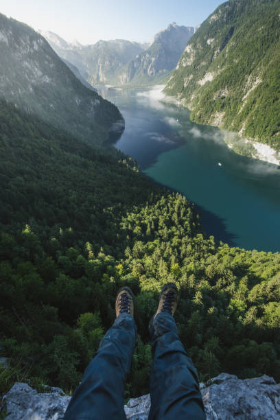 istock Hiker lets his feet hang over an abyss 842015254