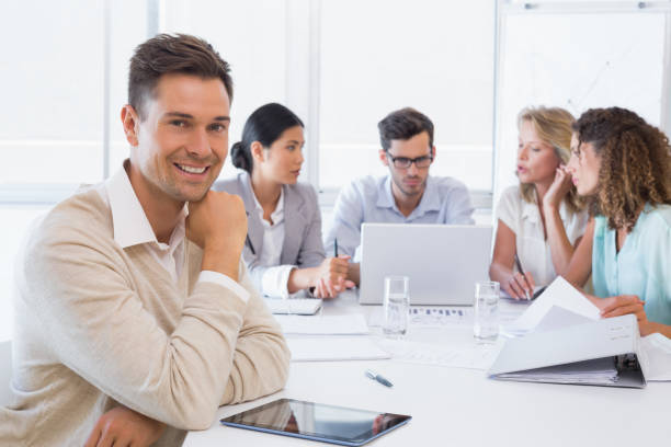 istock Casual businessman smiling at camera during meeting 842015992