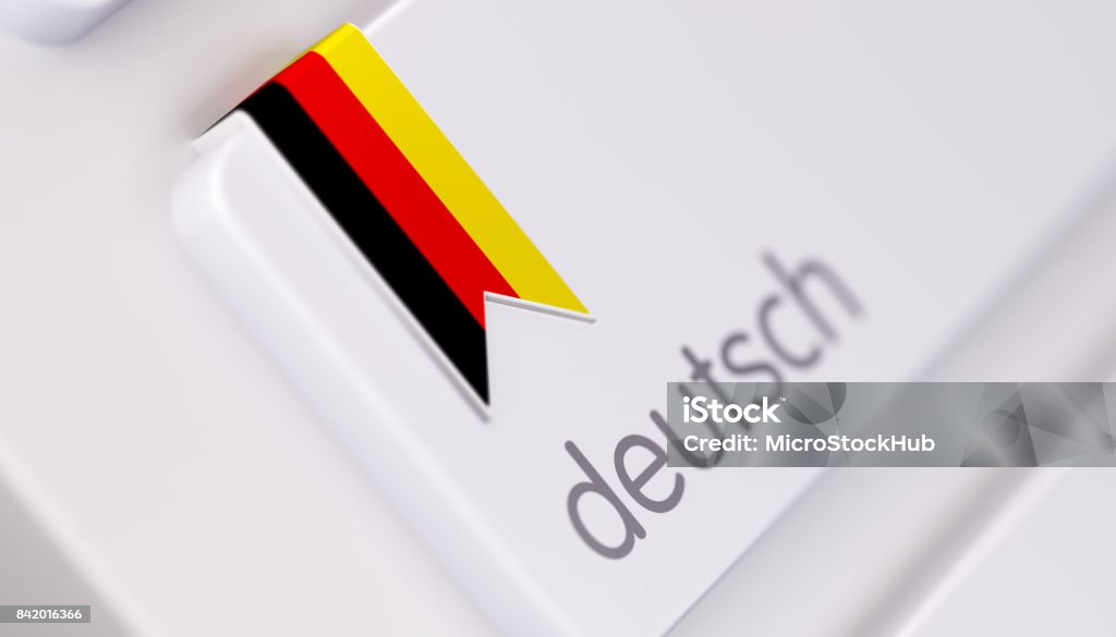 Modern Keyboard with German Language Option in German: Online Dictionary Concept High quality 3d render of a modern keyboard with German text and German flag. Derman keyboard button has a German flag icon on it and it is in focus. Horizontal composition with copy space. German Language Stock Photo