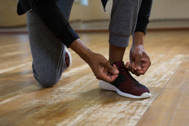 istock Low section of dancer tying shoelace on floor 842022642