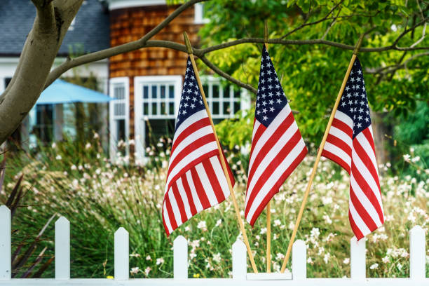 Patriotic 18 Flags in a southern California neighborhood. american flag flowers stock pictures, royalty-free photos & images