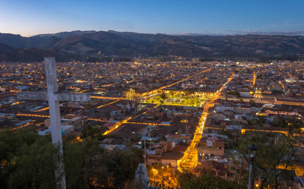 View of the city from the hill santa apolonia the city is dark and its limes are painted with light. cajamarca region stock pictures, royalty-free photos & images
