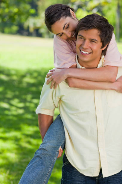 istock Woman looking at her friend while getting a ride on his back 842037004