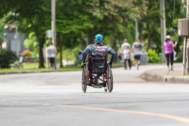 Disabled people marathon by wheelchair in a outdoor park Bangkok, Thailand - July 29, 2017 : Unidentified disabled people marathon by wheelchair in a outdoor park for exercise healthy paralympic games stock pictures, royalty-free photos & images