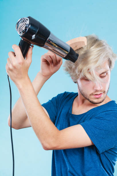 istock Trendy man with hair dryer 842054908