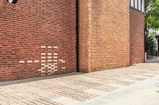 Red brick wall and empty floor sidewalk