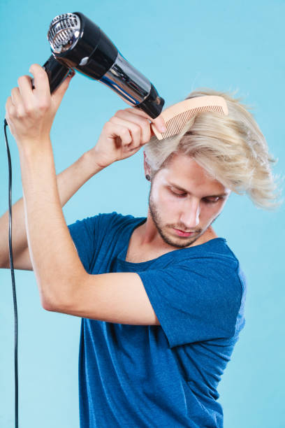 istock Trendy man with hair dryer 842065938