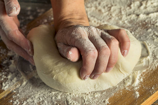 istock Handmade Organic Bread Dough in a Womans Hands 842069386