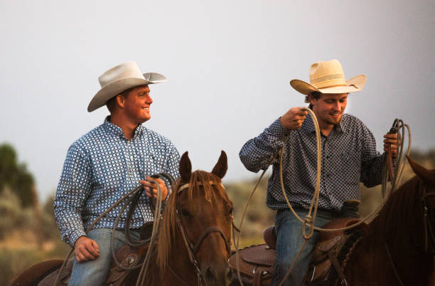 istock utah cowboys with stetson horseback riding at dusk 842079086