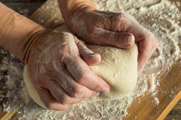 istock Handmade Organic Bread Dough in a Womans Hands 842079386