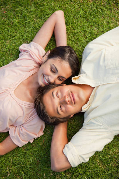 istock Woman looking at her friend while lying head to shoulder with him 842081792