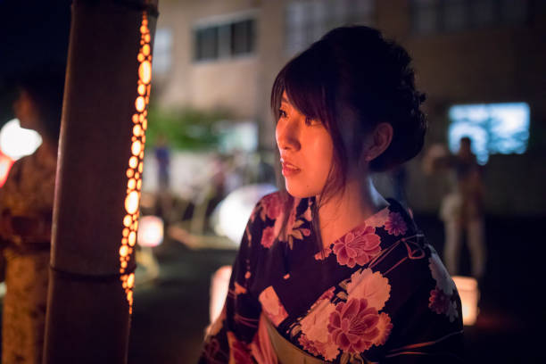 istock Young woman in yukata looking at candle lights in bamboo pole 842082178
