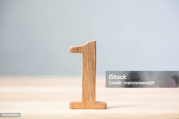 Number One Wood Material On Table Concept Top Winner Success Stock Photo - Download Image Now