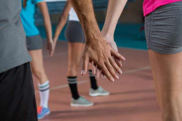 istock Mid section of volleyball players holding hands 842089648