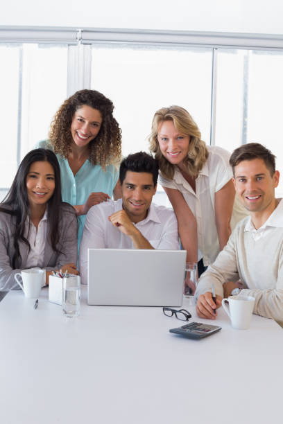 istock Casual smiling business team having a meeting using laptop 842090158