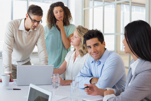 istock Casual business team having a meeting using laptop 842090254