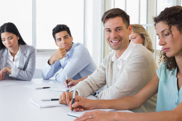 istock Casual businessman smiling at camera during meeting 842090316