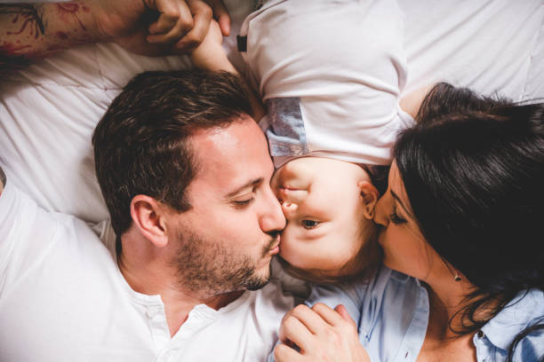 istock Loving parents with their cute little boy on bed 842090810