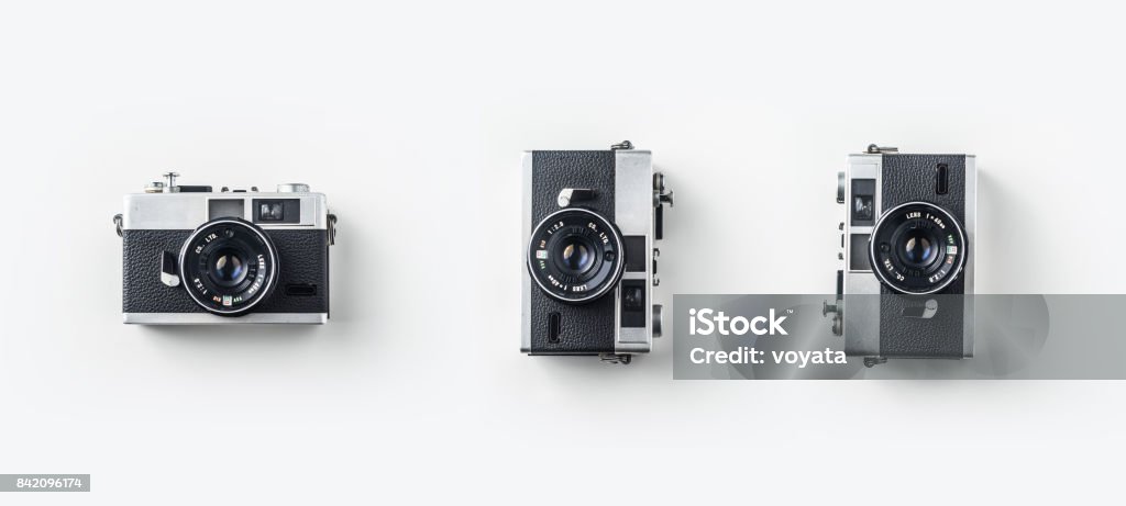 Top view of vintage cameras on white background desk for mockup Top view of vintage cameras on white background desk for mockup, collection of diverse angle. Camera - Photographic Equipment Stock Photo